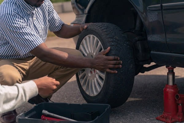 Flat tire being pulled off the wheel hub roadside